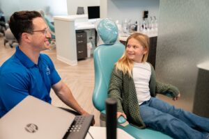 Dr. Zebriek consulting with a young patient in a modern orthodontic office at BZ Orthodontics, highlighting personalized care for Invisalign and braces in Lansdale, PA.
