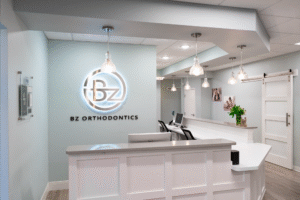 BZ Orthodontics office interior featuring reception area, modern design, and logo, representing orthodontic services in Lansdale, PA, including braces and Invisalign options.