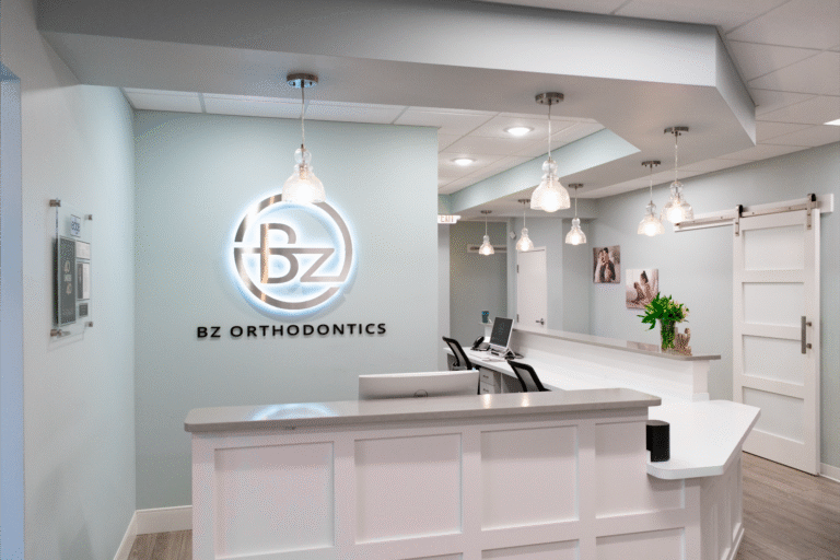 Reception desk with the lit BZ logo at the BZ Orthodontics Lansdale office