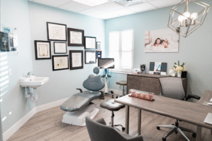 Orthodontic office interior of BZ Orthodontics featuring dental chair, desk, and framed certifications, representing Invisalign and braces services in Lansdale, PA.