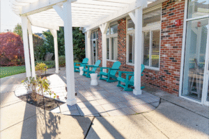 Patio area of BZ Orthodontics Lansdale office featuring turquoise chairs and a welcoming outdoor space, promoting a comfortable environment for patients seeking orthodontic services like Invisalign and braces.