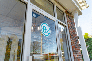 BZ Orthodontics office entrance featuring logo and contact information for Dr. Zebriek, showcasing orthodontic services in Lansdale, PA.