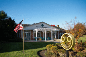 BZ Orthodontics office in Lansdale, featuring a welcoming exterior with American flag, vibrant landscaping, and prominent logo, highlighting orthodontic services including braces and Invisalign.