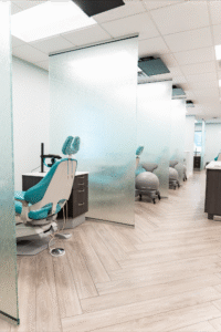 Modern orthodontic treatment area at BZ Orthodontics in Lansdale, featuring dental chairs, partitions, and a clean, welcoming environment for patients seeking braces and Invisalign services.
