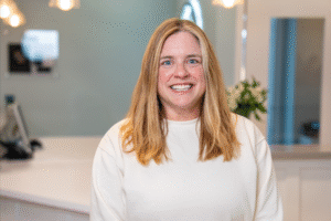 Patient smiling in BZ Orthodontics office, showcasing clear braces treatment, highlighting orthodontic services in Lansdale, PA.
