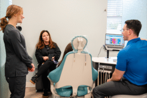 Patient consultation at BZ Orthodontics with Dr. Zebriek, discussing Invisalign options in a modern orthodontic office setting.