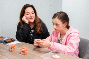 Mother and daughter discussing orthodontic treatment options at BZ Orthodontics, showcasing Invisalign and braces for children in Lansdale, PA.