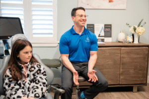 Dr. Zebriek at BZ Orthodontics consulting with a young patient in a welcoming orthodontic office setting, emphasizing patient care and comfort for Invisalign and braces in Lansdale, PA.