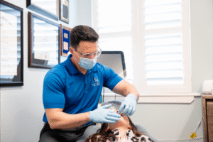 Orthodontist Dr. Zebriek providing Invisalign consultation at BZ Orthodontics in Lansdale, PA, with patient receiving care in a welcoming office environment.