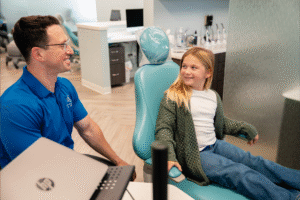 Dr. Zebriek interacting with young patient in dental chair at BZ Orthodontics, showcasing friendly orthodontic care in Lansdale, PA.