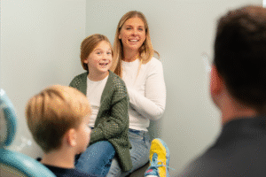 Smiling mother and daughter in orthodontic office, showcasing friendly environment at BZ Orthodontics, highlighting patient care and comfort for families considering Invisalign and braces in Lansdale, PA.