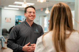 Dr. Brian Zebrick smiling and engaging with a patient in the BZ Orthodontics office, highlighting personalized care for Invisalign and braces in Lansdale PA.