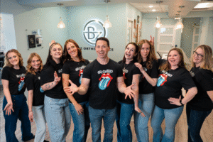 BZ Orthodontics team with Dr. Zebriek, smiling and posing in office, showcasing friendly orthodontic care in Lansdale, PA.