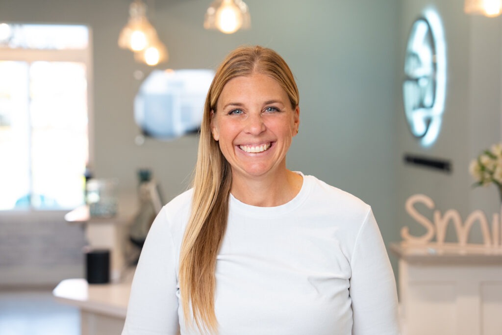 Smiling female patient consulting with an orthodontist at BZ Orthodontics, discussing treatment options like Invisalign in Lansdale, surrounded by informational materials about braces and orthodontics.
