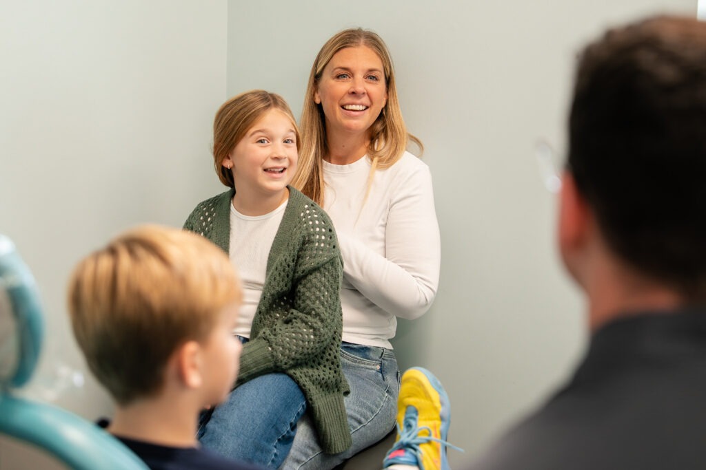 Smiling mother and daughter in orthodontic office, showcasing friendly environment at BZ Orthodontics, highlighting patient care and comfort for families considering Invisalign and braces in Lansdale, PA.